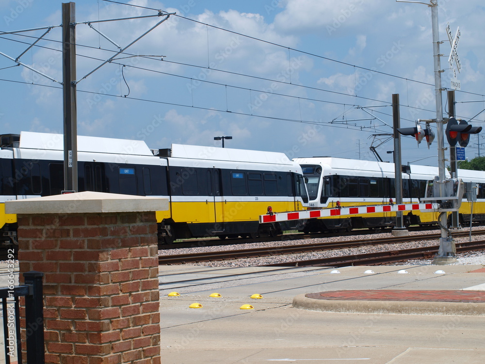 Obraz premium Light Rail Train at a Crossing