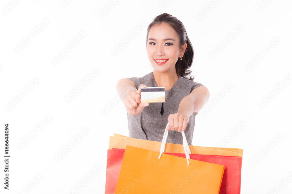 Beautiful Asian Woman showing credit card and holding shopping bags,Isolated on white background Beautiful Asian Woman showing credit card and holding shopping bags,Isolated on white background