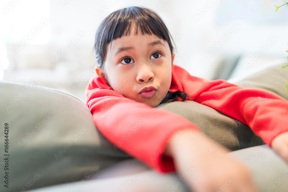 Cute little girl lying on sofa Cute little girl lying on sofa