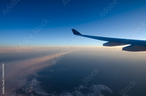 Airplane wing and blue sky © Surakit