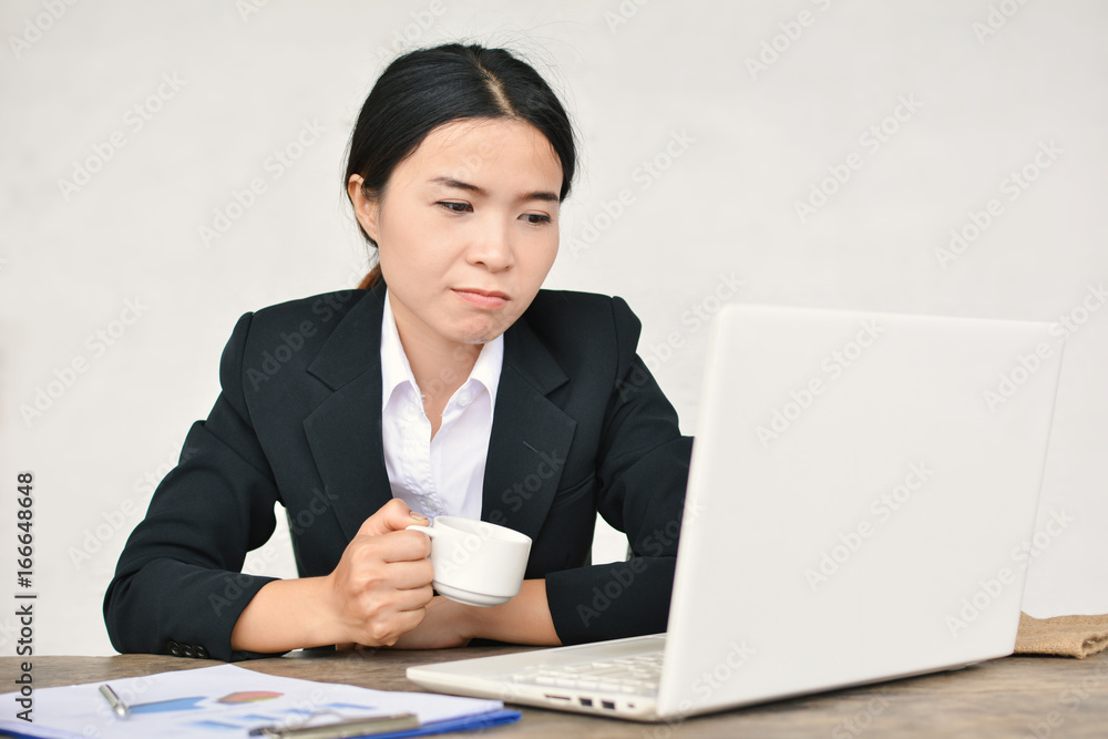 Close up of businesswomen drinking coffee during working in office selective and soft focus Close up of businesswomen drinking coffee during working in office selective and soft focus