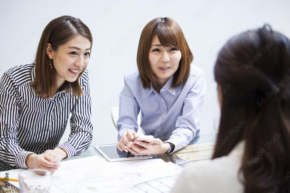 Three women are having meetings at a trendy office Three women are having meetings at a trendy office