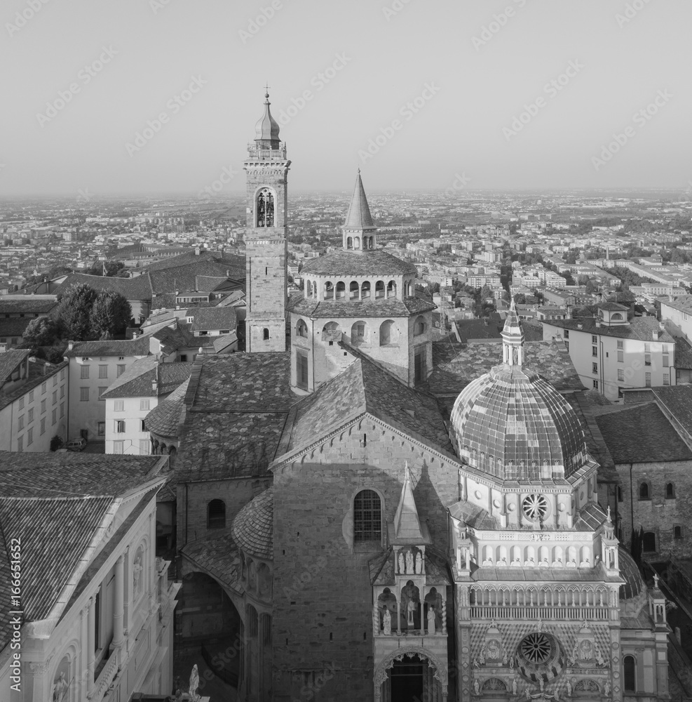 Bergamo, old city, drone aerial view of the Basilica of Santa Maria Maggiore and the chapel Colleoni. In the background the Padana plain