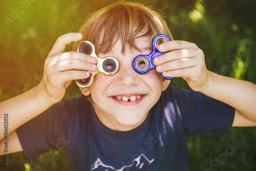 Konstfotografi Happy boy with two spinners