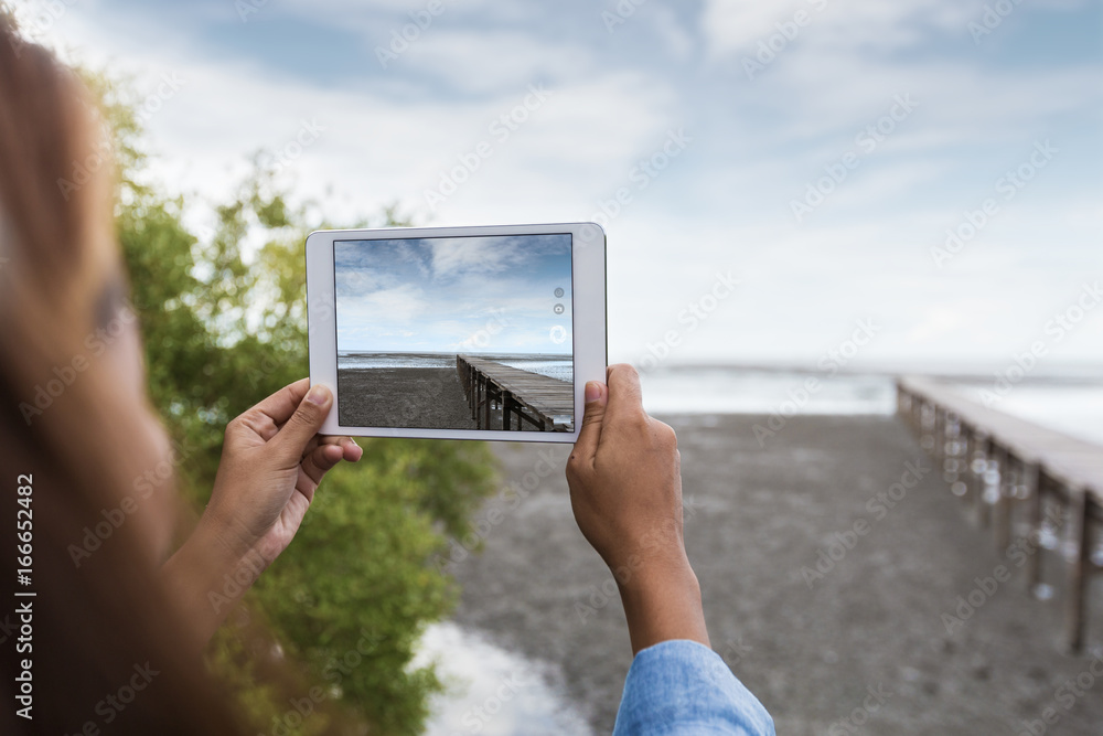 woman use digital tablet taking landscape photo