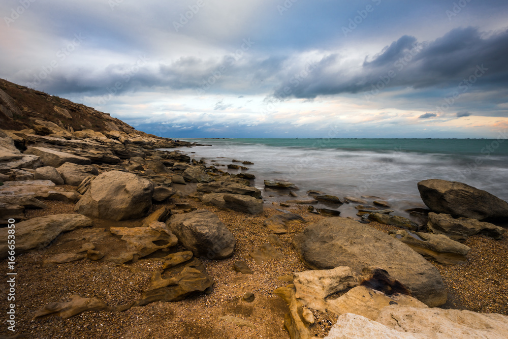 Seashore in cloudy weather, storm on sea Seashore in cloudy weather, storm on sea
