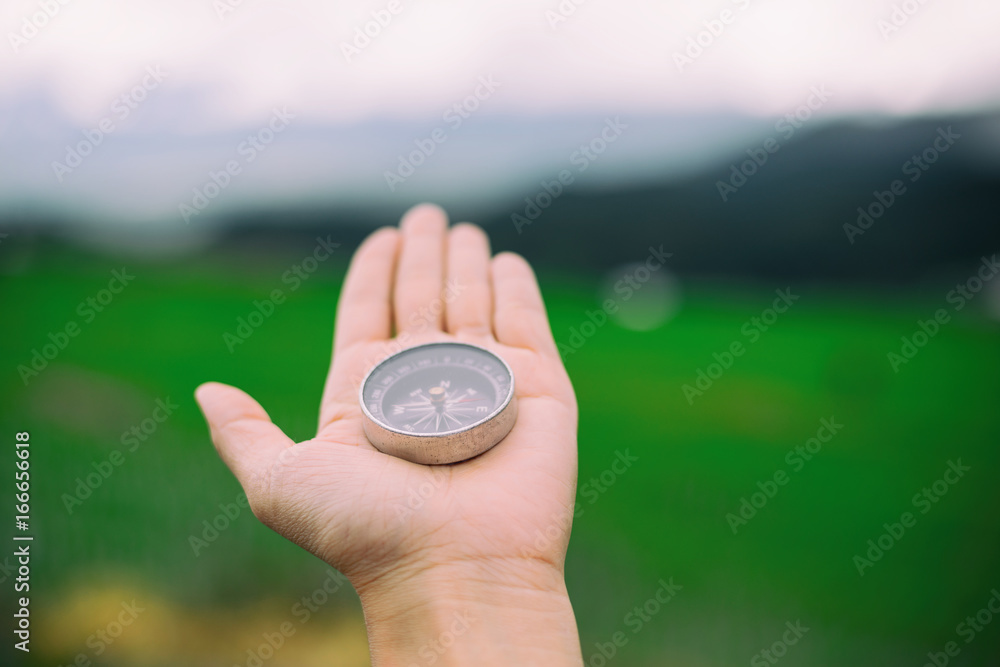 traveler woman search location with compass in mountains