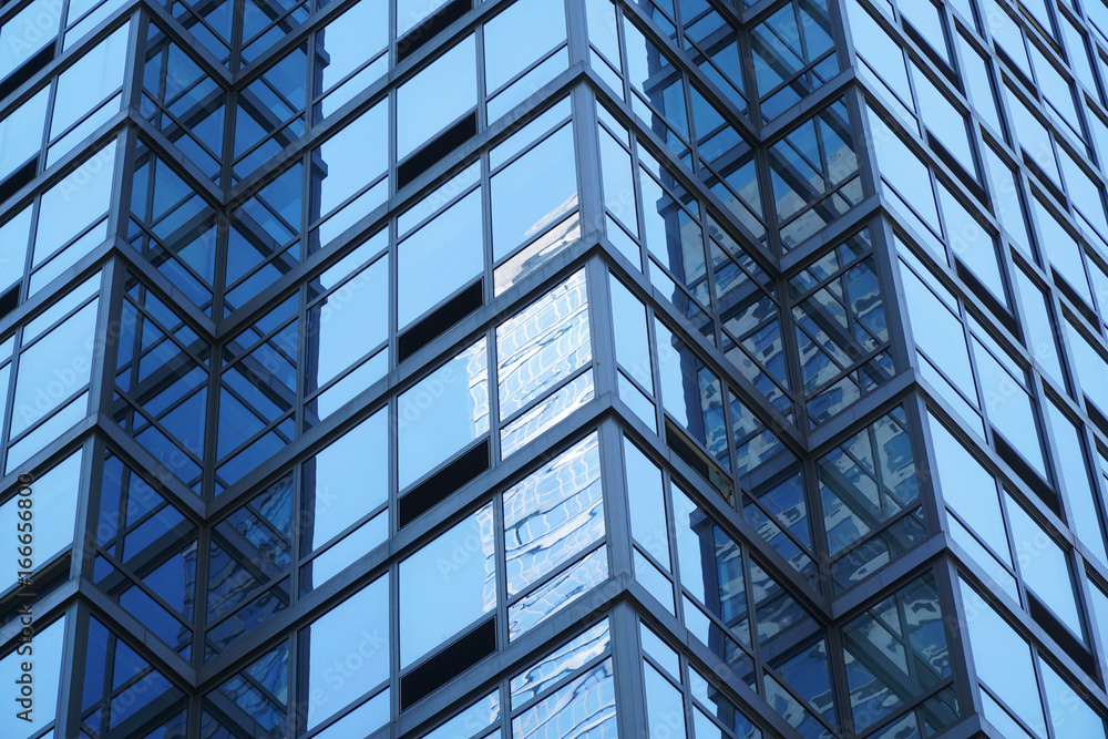 close up on modern office building with blue glass windows close up on modern office building with blue glass windows