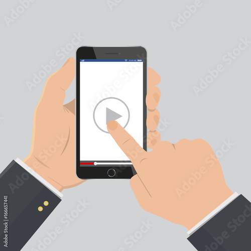 Hand pointing to play button on a smartphone to watch video tutorial.