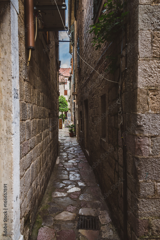Narrow stone street of cobblestone in Kotor Old Town, Montenegro.