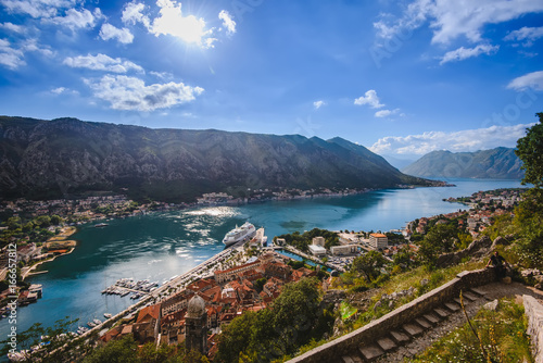 Kotor Bay and Old Town panorama from above Kotor's castle of San Giovanni. Mountains, traditional house roofs and Boka Kotorska fjord wide angle view.