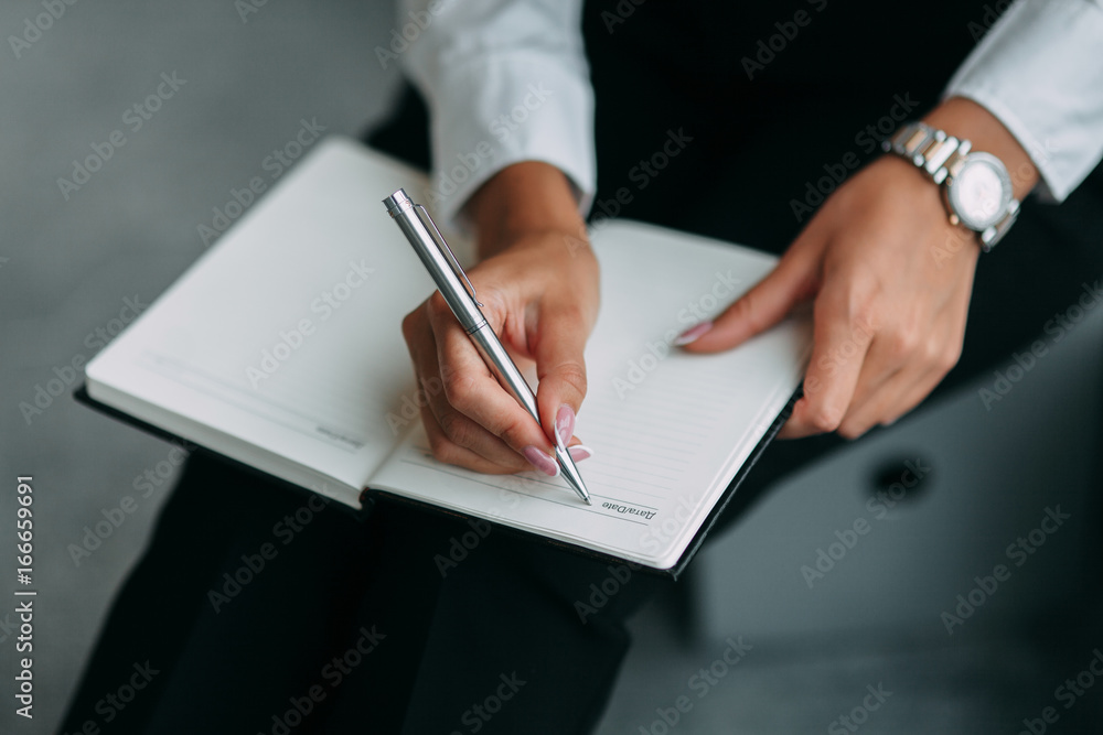 Hand on notebook Hand on notebook