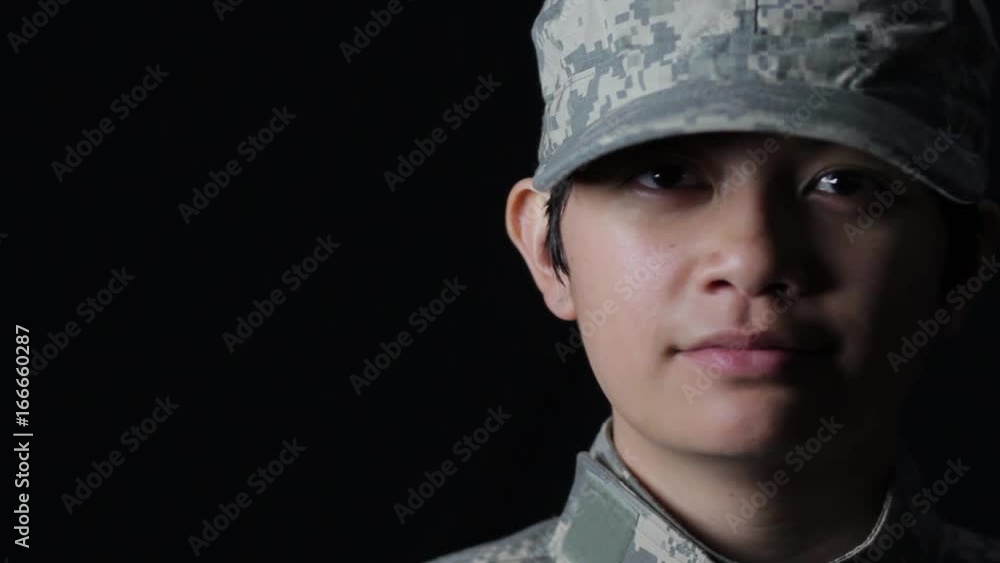 Woman soldier turning towards the camera Woman soldier turning towards the camera