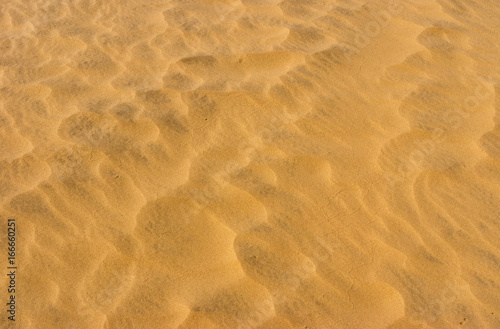 Waves of sand in hot desert - aerial view