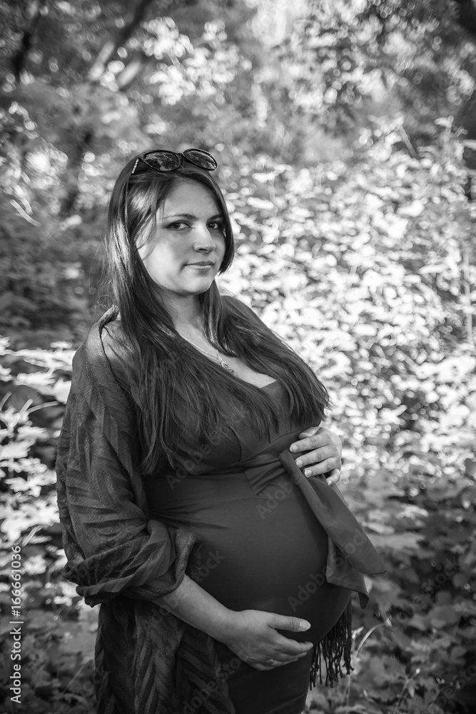 Monochrome photo of pregnant woman in the forest Monochrome photo of pregnant woman in the forest