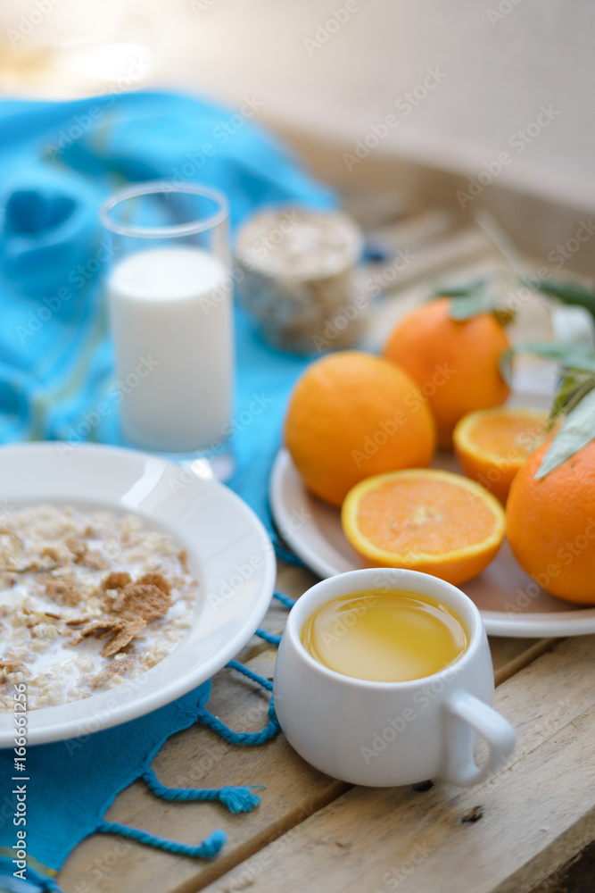 Healthy breakfast, fruit, corn flakes, milk and orange juice on the wooden table Healthy breakfast, fruit, corn flakes, milk and orange juice on the wooden table