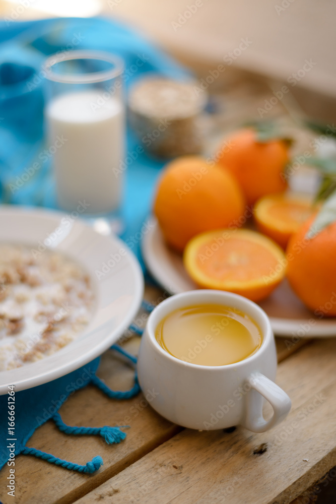 Healthy breakfast, fruit, corn flakes, milk and orange juice on the wooden table Healthy breakfast, fruit, corn flakes, milk and orange juice on the wooden table