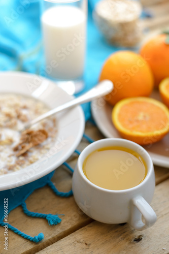 Healthy breakfast, fruit, corn flakes, milk and orange juice on the wooden table