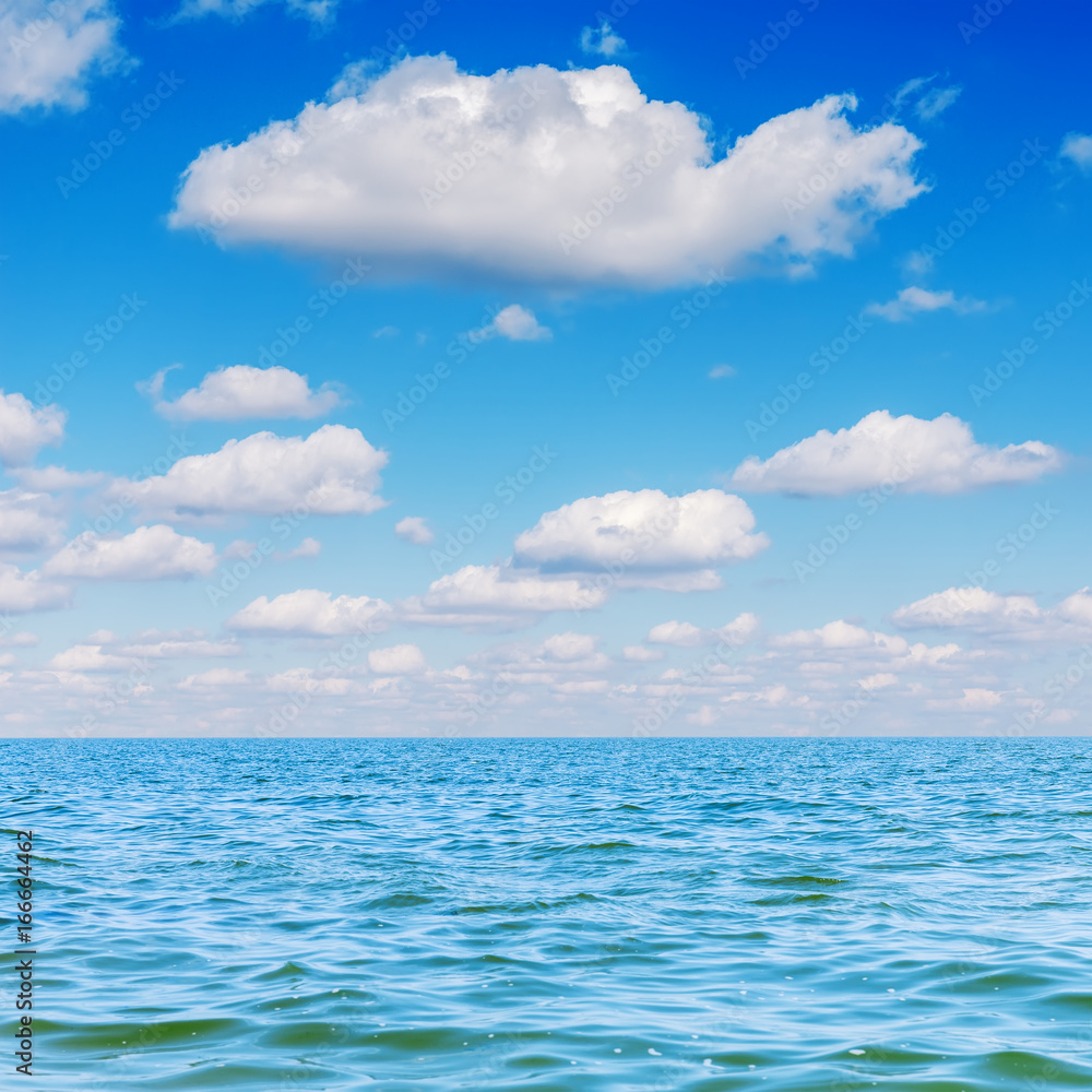 blue sea and clouds in sky over it blue sea and clouds in sky over it