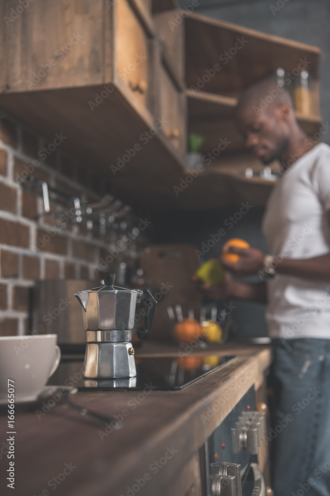 Cup and coffee pot on kitchen table Cup and coffee pot on kitchen table
