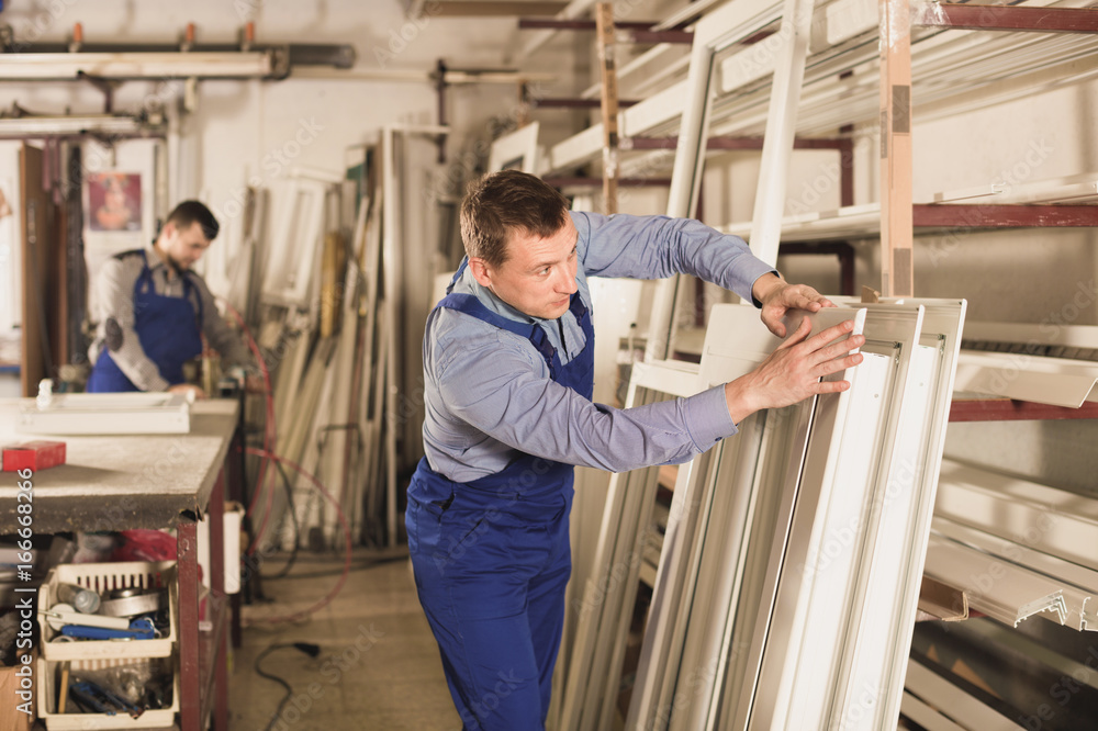 Workmen inspecting PVC manufacturing output in workshop