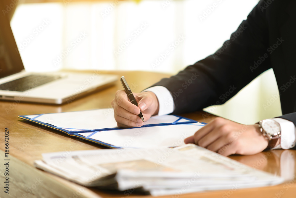 business man signing contract document in office business man signing contract document in office