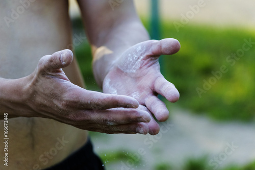 The young man sprinkle his hands with powder