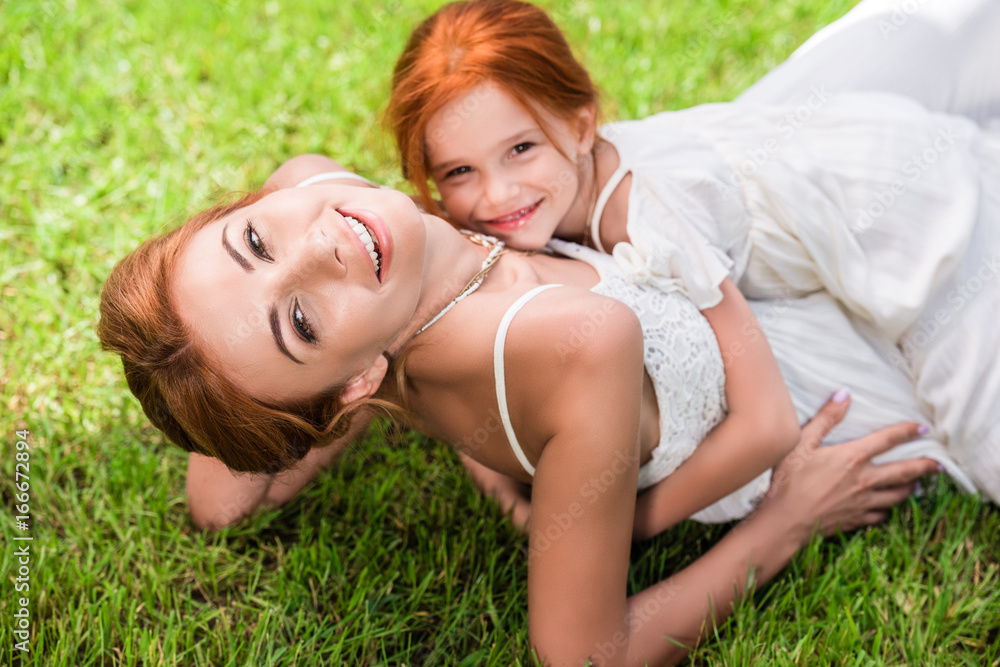 mother and daughter hugging at park mother and daughter hugging at park