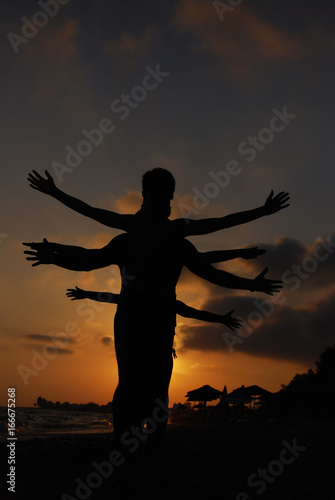 Silhouette of one body with lot of hands. Happy family play on summer vacation