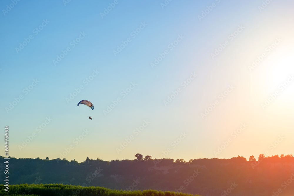 Silhouette of paraglider and evening sky Silhouette of paraglider and evening sky