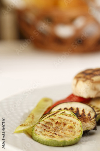 Grilled vegetables arranged on a plate, Traditional dish in elegant setting, Selective focus with soft light