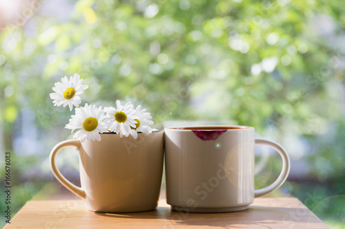 Wallpaper Mural Two mugs nearby. One of daisies, the other with prints of lipstick. The concept of the solar in the morning. The summer mood. Torontodigital.ca
