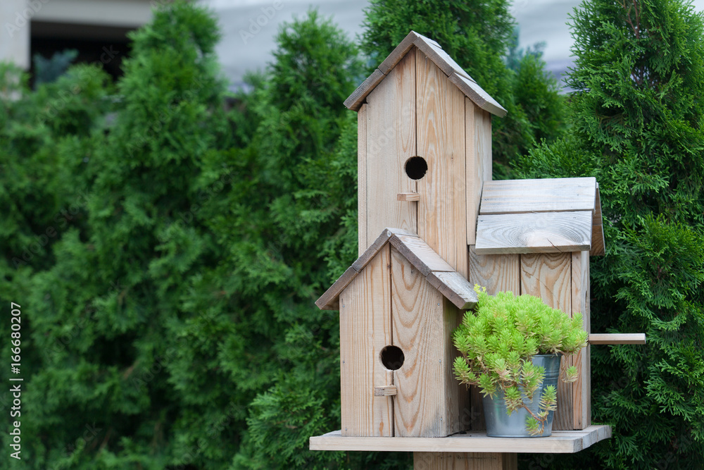 Handmade wooden birdhouse in the park Handmade wooden birdhouse in the park