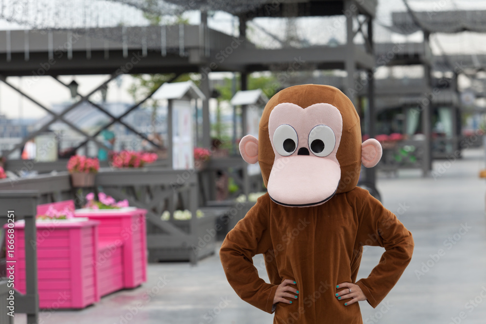 A man in a monkey costume is standing on the street Stock Photo | Adobe  Stock