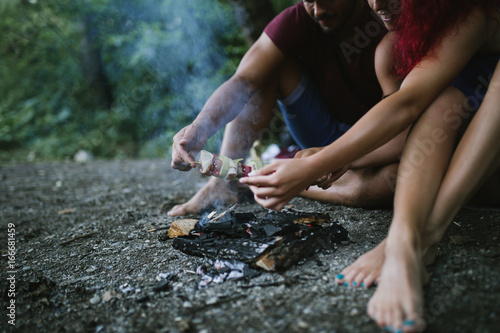 Young happy couple enjoying camping and hiking in wild nature. 