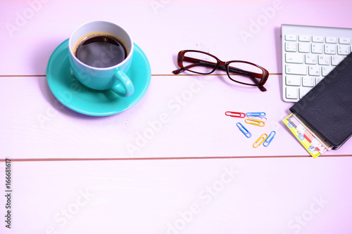 Modern workplace with a cup of coffee and a computer keyboard, top view