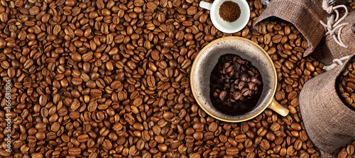 Coffee background, top view with copy space. White cup of coffee and, ground coffee, coffee beans o background