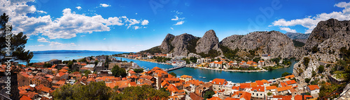 Panoramic view of the Omis on Adriatic sea surrounded by high mountains with amazing canyon of river Cetina, Dalmatia, Croatia.