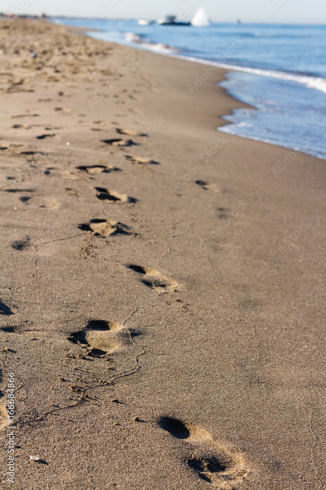 Footprints in the sand by the sea Footprints in the sand by the sea