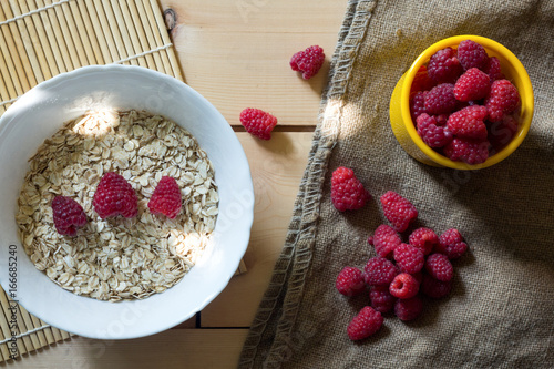 Healthy breakfast with berries on white wooden background. Healthy eating oatmeal. Top view. Copy space