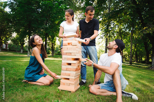 Jenga, group game of physical skill with big blocks. photo