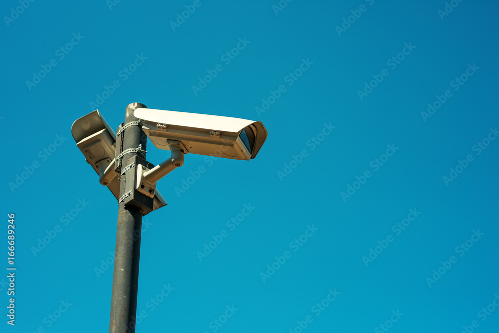 Two CCTV security cameras mounted on high post Two CCTV security cameras mounted on high post