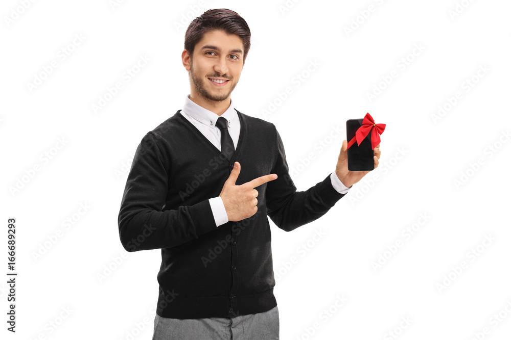 Elegant young man pointing at a phone as a present Elegant young man pointing at a phone as a present