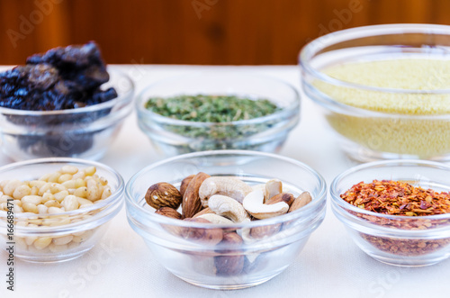 Variety of ingredients for couscous cooking in glass bowls