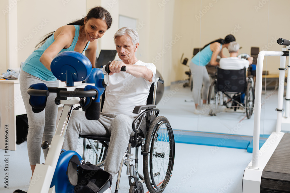 Positive delighted woman standing near her patient Positive delighted woman standing near her patient