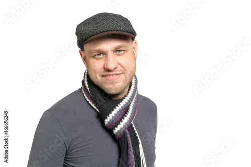 Portrait of a man in a gray cap and a gray scarf. Isolated.