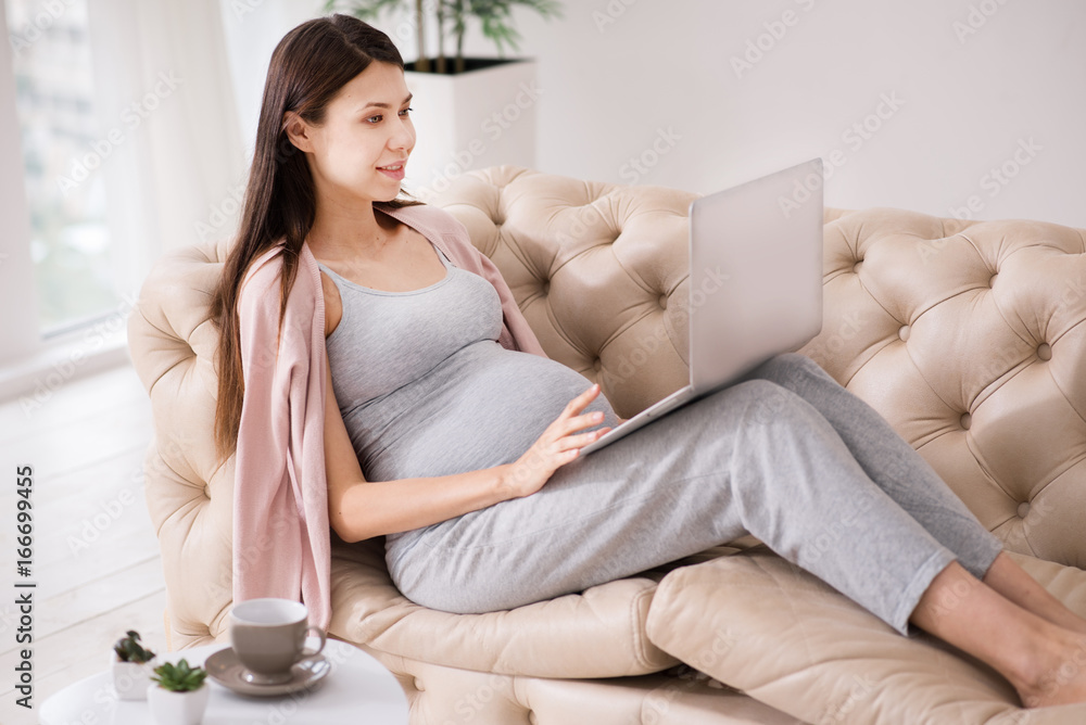 Serious brunette using her laptop Serious brunette using her laptop