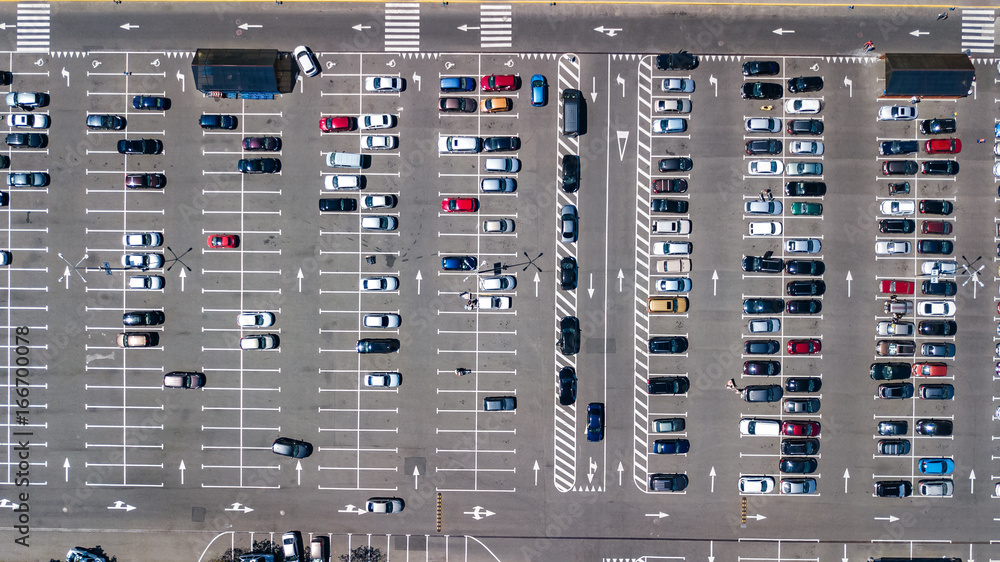 Aerial view of parking lot with many cars from above, transportation