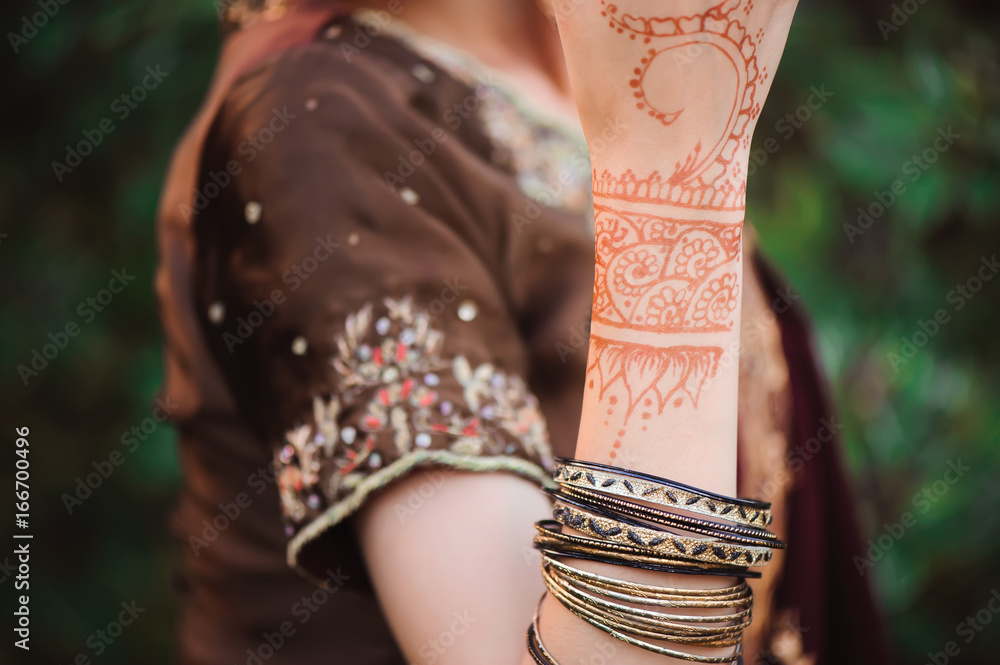 Mehndi covers hands of Indian woman