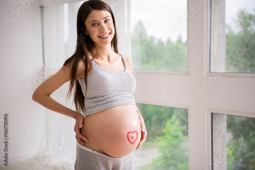 Free Download Positive brunette woman posing on camera - GFXLoad
